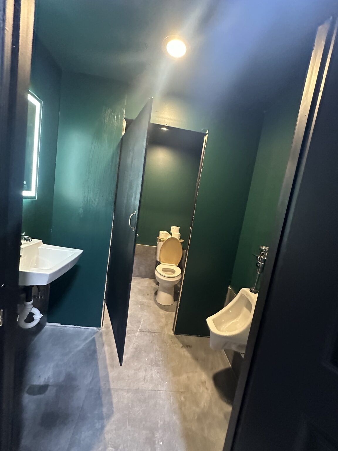 Commercial restroom with toilet urinal and sink installations