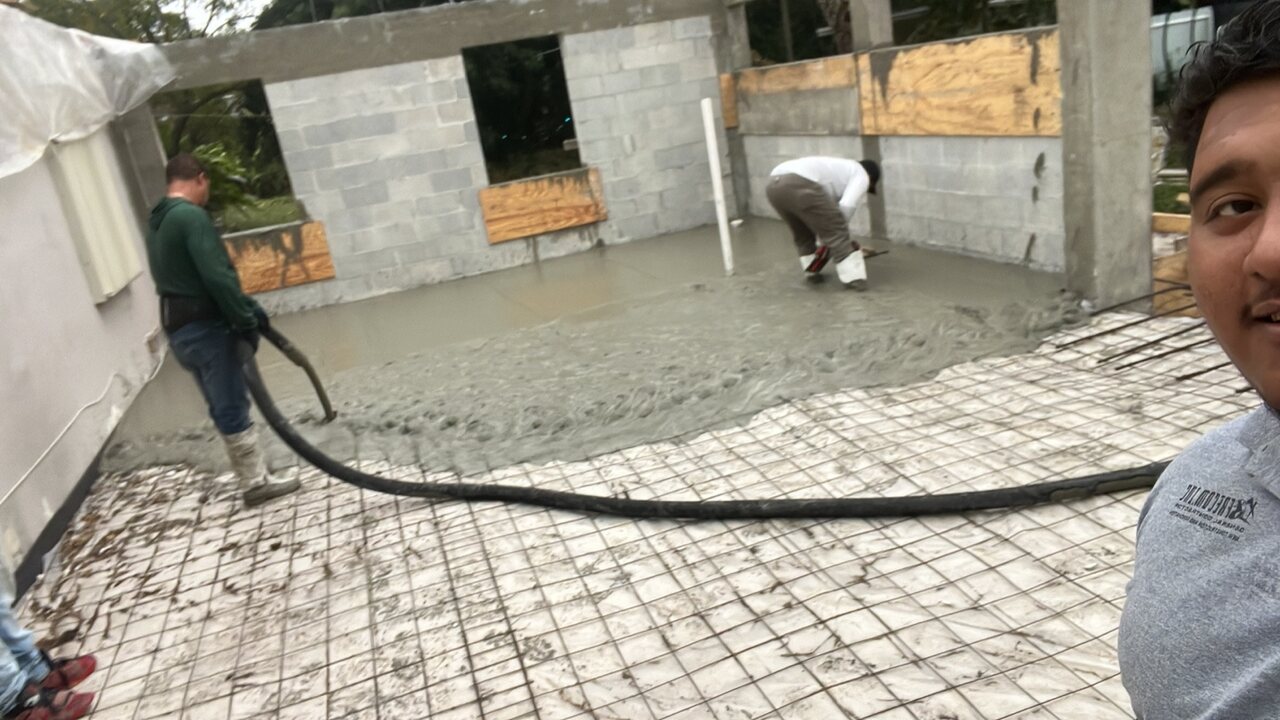 Concrete slab placement over reinforcing steel