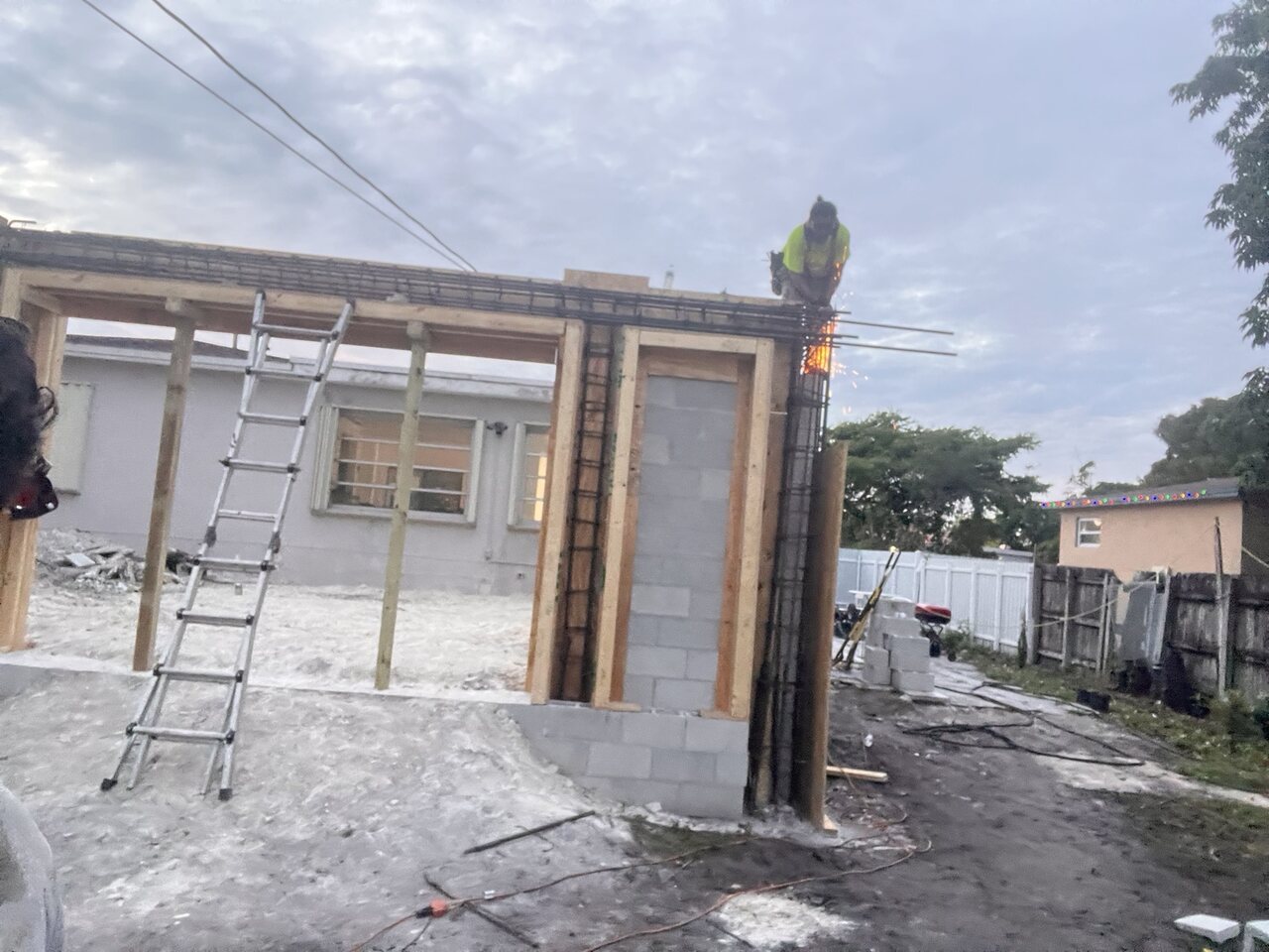 Welder joining reinforcing steel on a tie beam